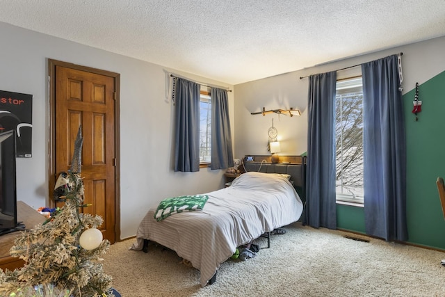 carpeted bedroom featuring a textured ceiling