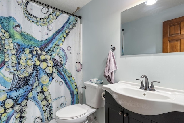 bathroom featuring vanity, a textured ceiling, and toilet