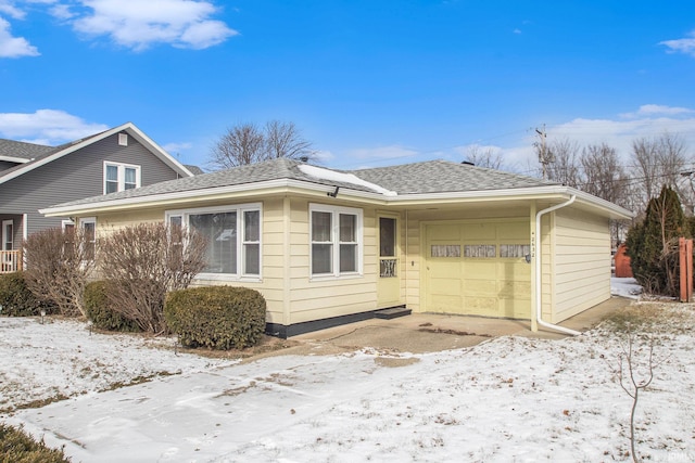 view of snowy exterior with a garage