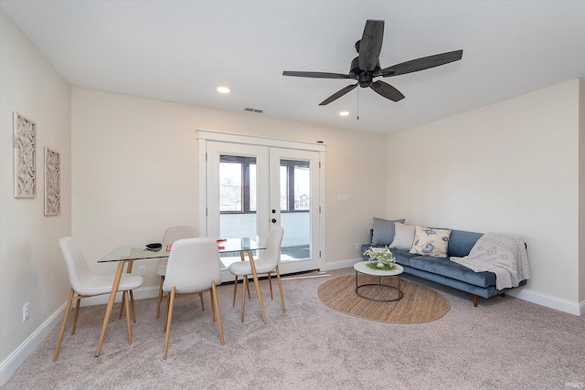 interior space featuring french doors, ceiling fan, and light carpet