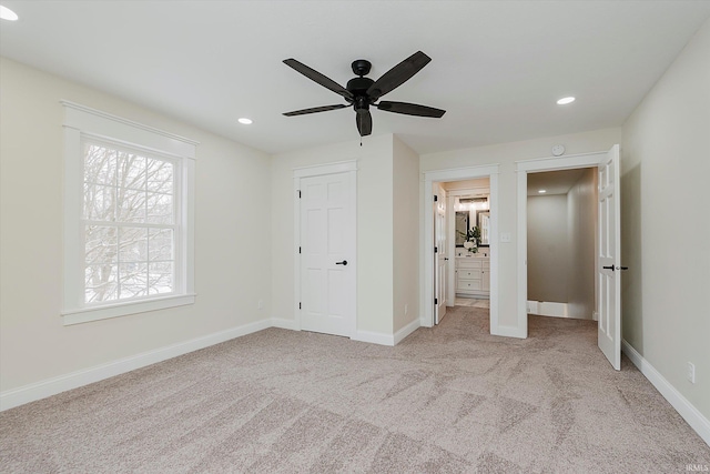 unfurnished bedroom featuring light colored carpet and ceiling fan