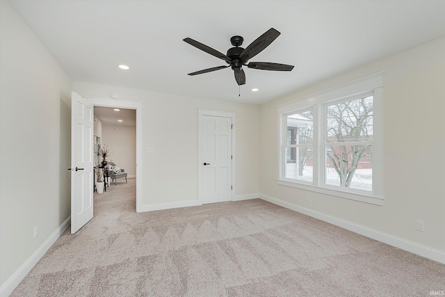 unfurnished bedroom with light colored carpet and ceiling fan