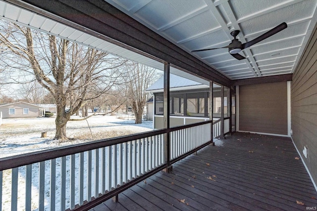 snow covered deck featuring ceiling fan and a sunroom