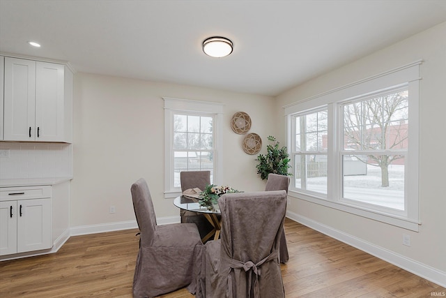 dining space with light hardwood / wood-style floors