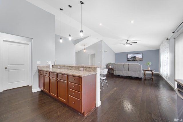 kitchen featuring pendant lighting, lofted ceiling, light stone counters, kitchen peninsula, and dark wood-type flooring