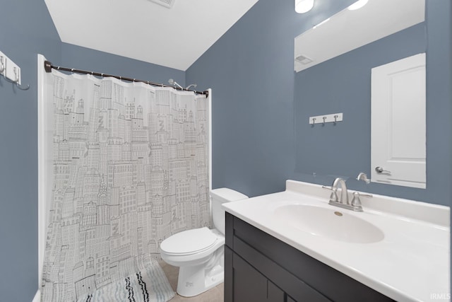 bathroom with vanity, curtained shower, and toilet