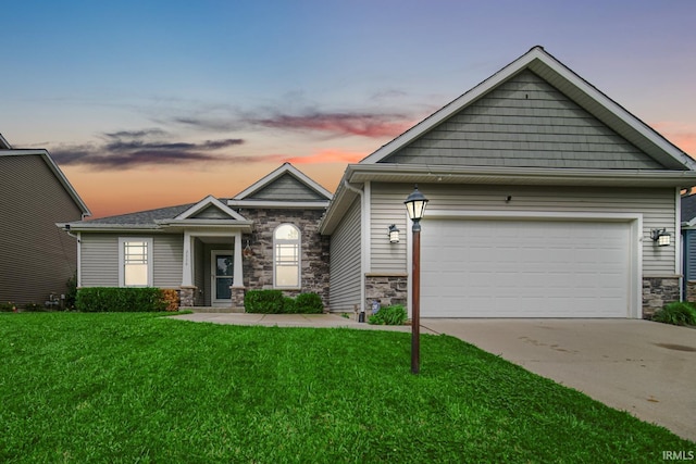 craftsman-style house featuring a garage and a yard