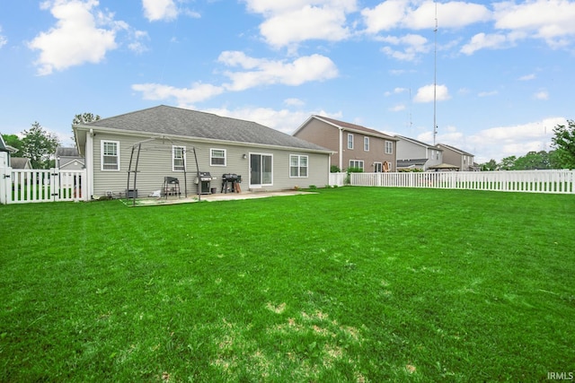 rear view of property with a patio and a yard