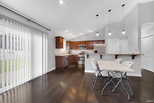 dining area with lofted ceiling, dark hardwood / wood-style floors, and sink