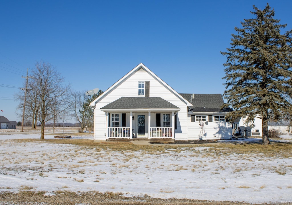 view of front of property with roof with shingles and covered porch