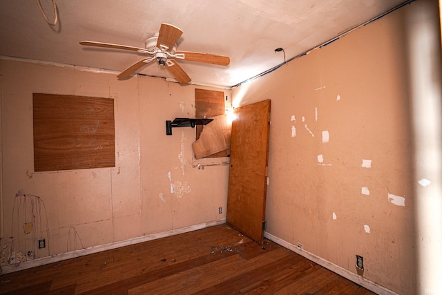 empty room with dark hardwood / wood-style flooring and ceiling fan