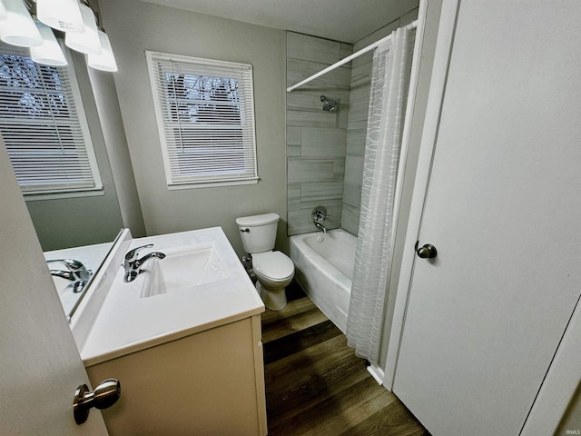 full bathroom featuring vanity, hardwood / wood-style floors, toilet, and shower / bath combo with shower curtain