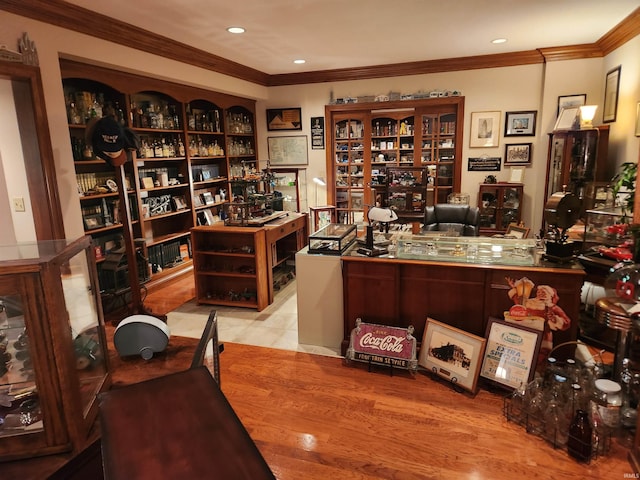 home office with crown molding and light wood-type flooring