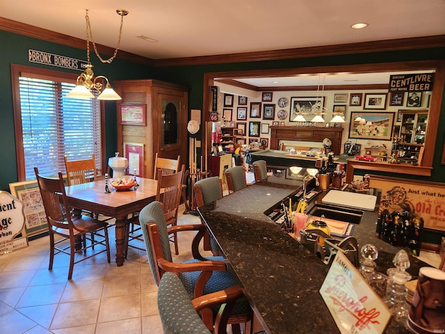 dining room featuring ornamental molding, light tile patterned floors, and an inviting chandelier