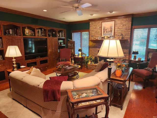 tiled living room with ornamental molding, brick wall, and ceiling fan