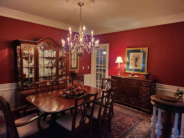 dining area featuring crown molding and a chandelier