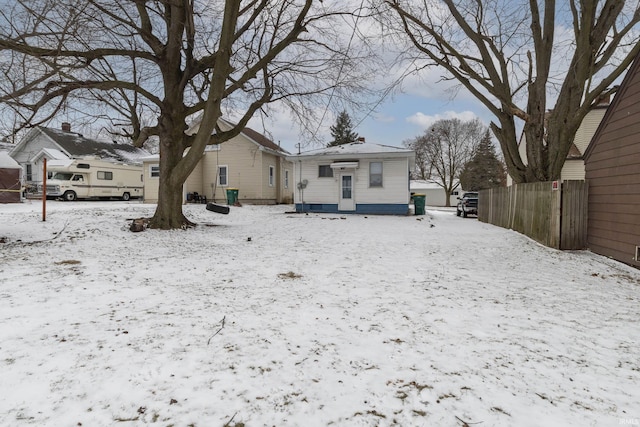 view of snow covered back of property