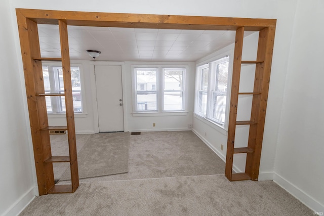 view of carpeted foyer entrance