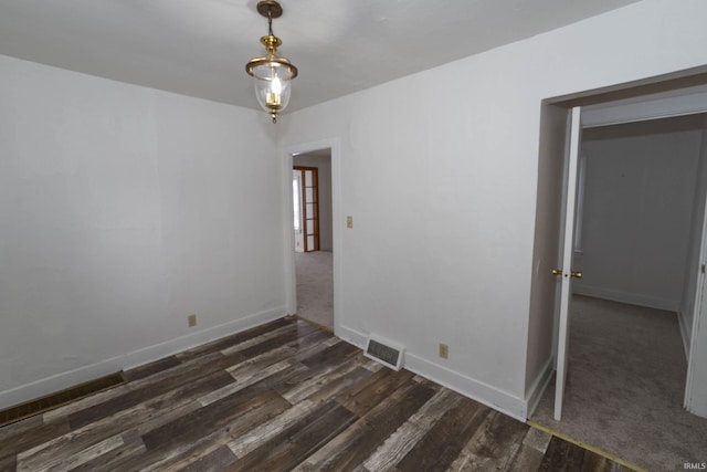 empty room featuring dark wood-type flooring