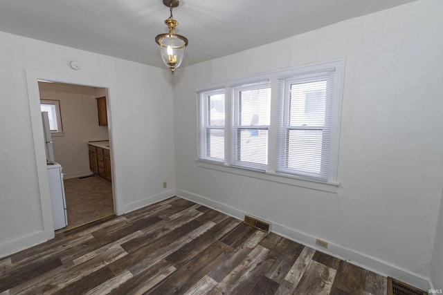 unfurnished dining area with dark hardwood / wood-style flooring