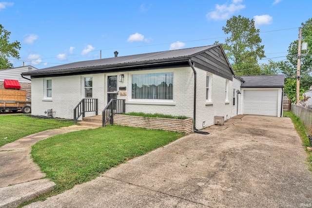 ranch-style home with a garage, an outdoor structure, and a front yard