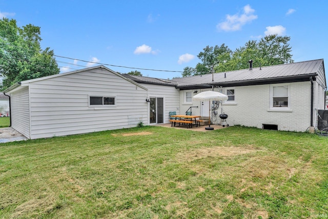 back of house featuring a yard and a patio