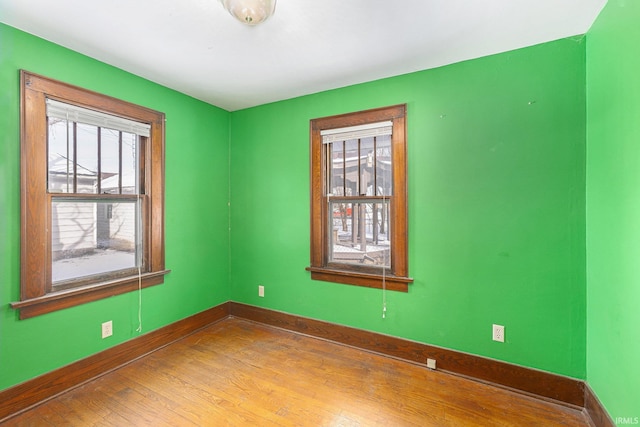 unfurnished room with hardwood / wood-style floors and a wealth of natural light