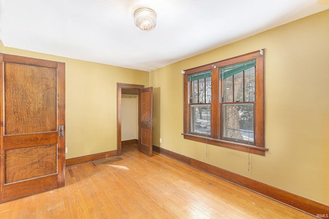 unfurnished bedroom with light wood-type flooring