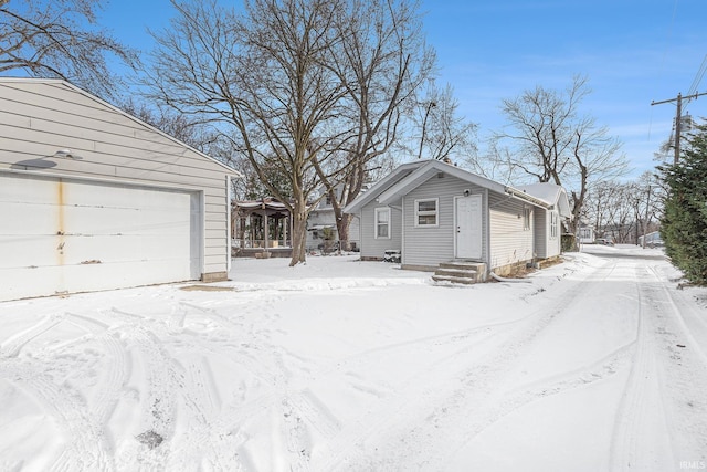 snow covered property featuring a garage