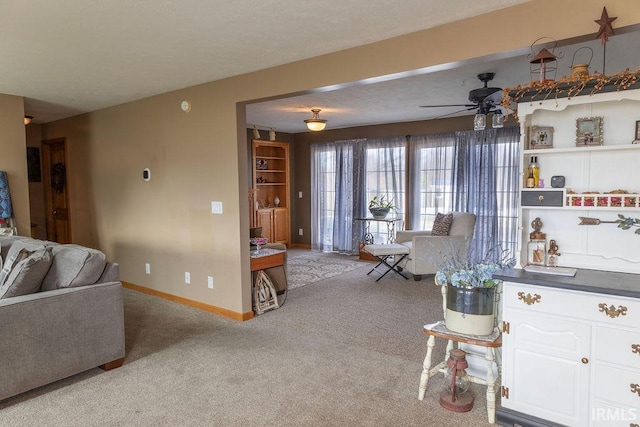 carpeted living room with ceiling fan