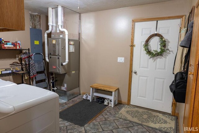 interior space featuring heating unit and washer and clothes dryer