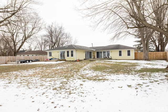 view of snow covered back of property