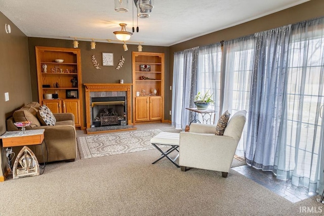 carpeted living room featuring a tile fireplace