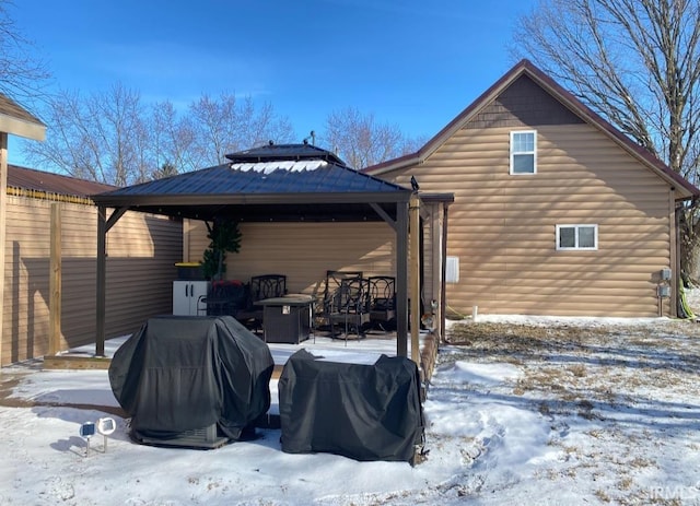 snow covered house with a gazebo