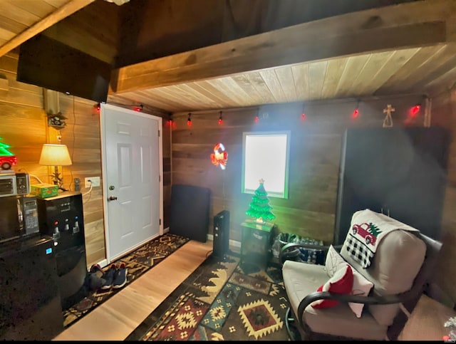 living room with hardwood / wood-style flooring, beamed ceiling, wood ceiling, and wood walls