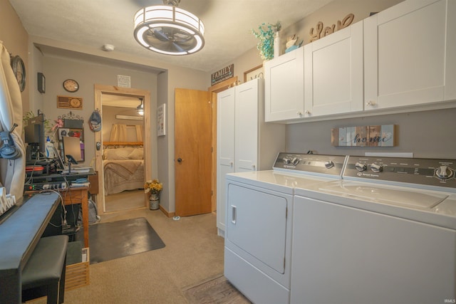 laundry room featuring independent washer and dryer and cabinets