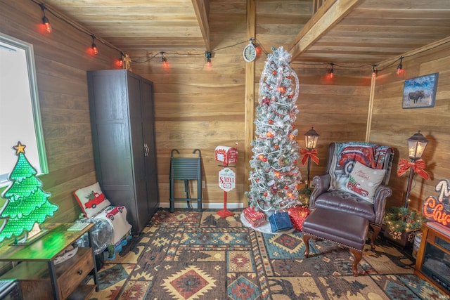 living area featuring wood ceiling and wooden walls