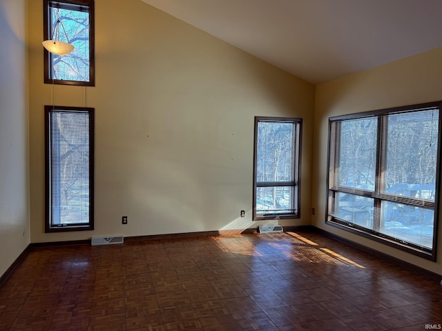 spare room featuring high vaulted ceiling