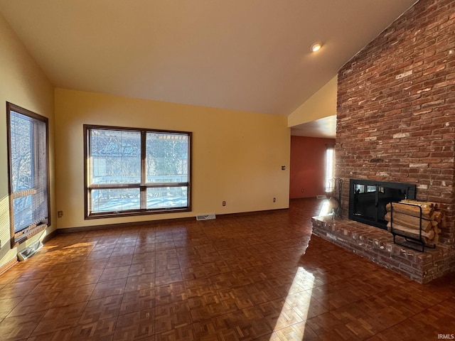 unfurnished living room with vaulted ceiling, dark parquet flooring, and a fireplace