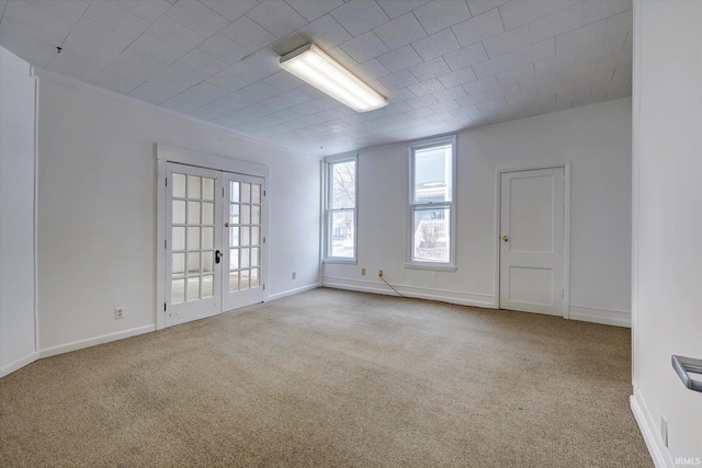 spare room with french doors and light carpet