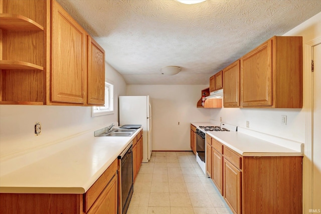 kitchen featuring white appliances, sink, and a textured ceiling