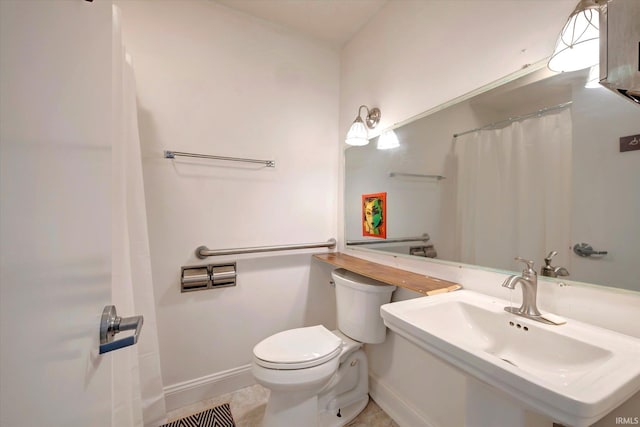 bathroom featuring sink, tile patterned floors, and toilet