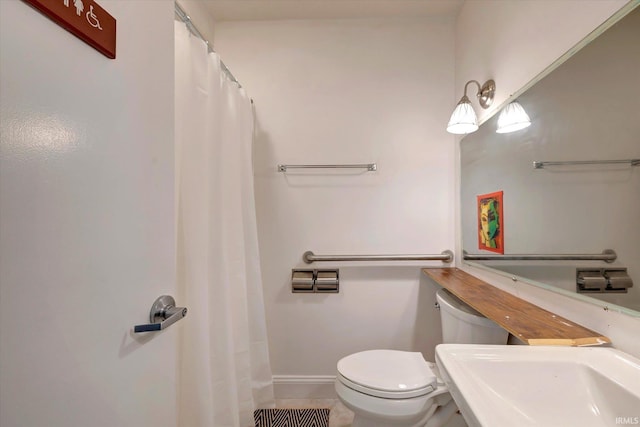 bathroom with tile patterned floors, toilet, and sink