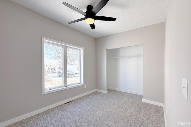 unfurnished bedroom with light carpet, ceiling fan, and a closet