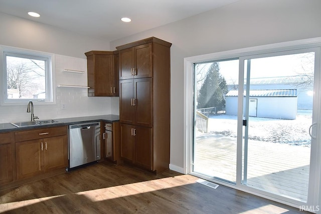 kitchen featuring dark hardwood / wood-style flooring, sink, decorative backsplash, and stainless steel dishwasher