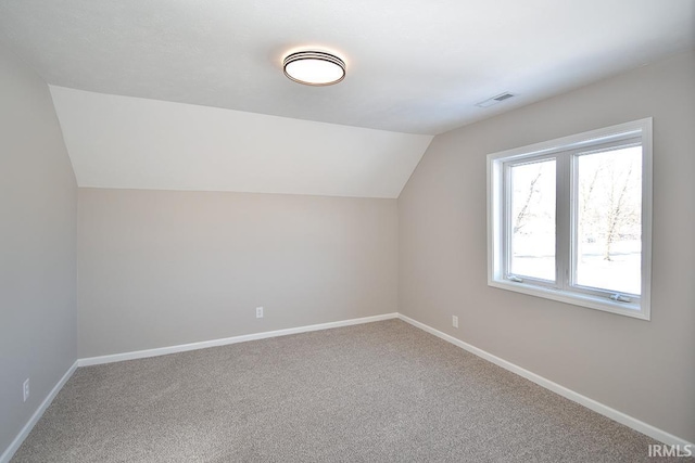 bonus room featuring vaulted ceiling and carpet flooring