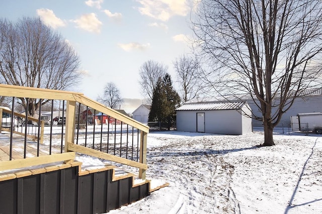 yard covered in snow with a storage unit