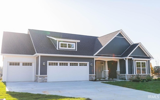 craftsman-style home with a porch and a garage