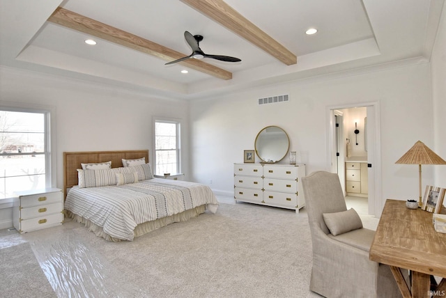 bedroom featuring crown molding, ceiling fan, connected bathroom, a tray ceiling, and light colored carpet