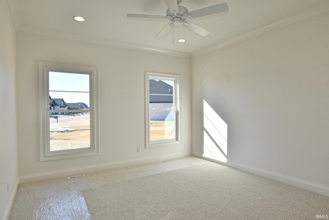 carpeted spare room featuring ornamental molding and ceiling fan